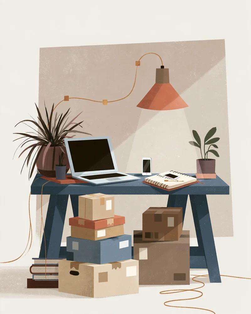 A home studio desk with a laptop, sketchbook and parcel boxes